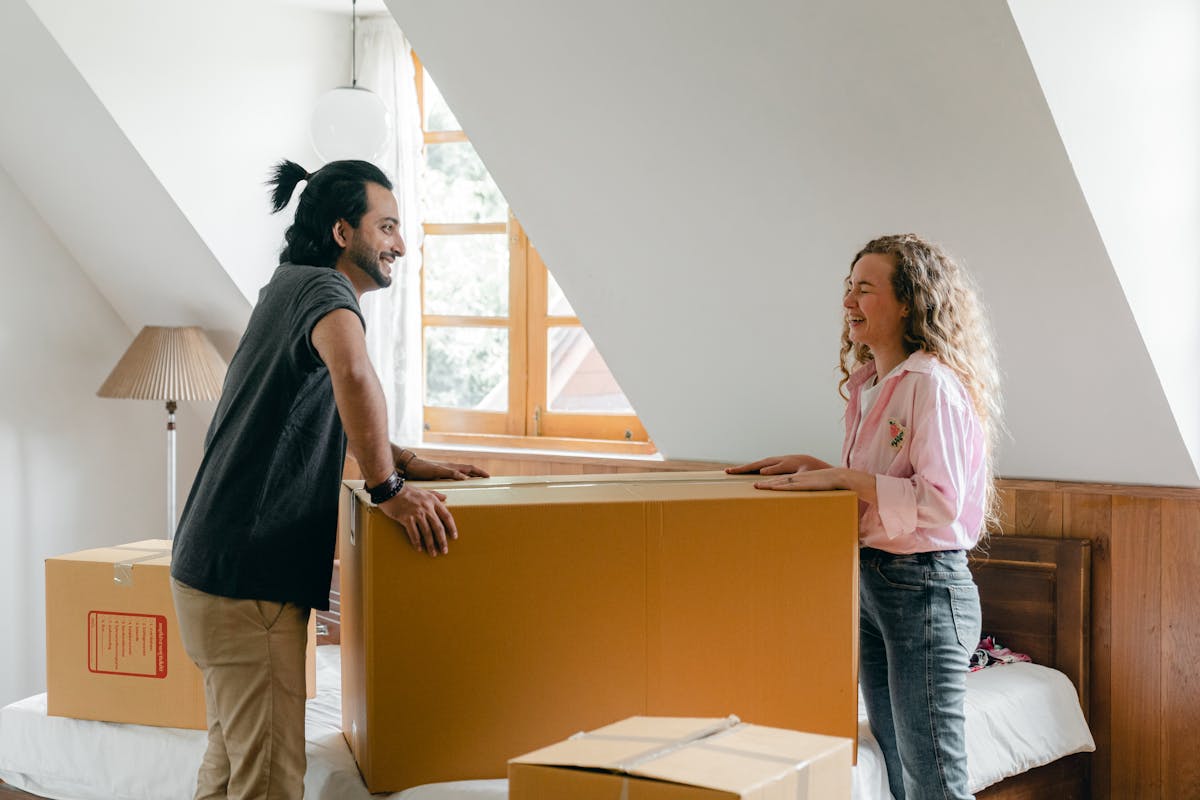 A couple unpacking boxes together in a new home.